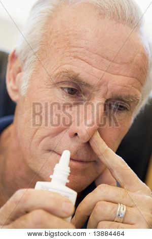 Senior Man Using Nasal Spray