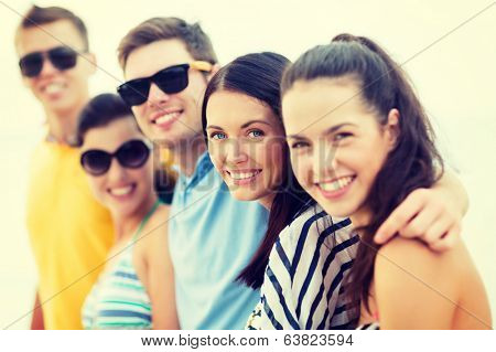 summer, holidays, vacation, happy people concept - group of friends having fun on the beach