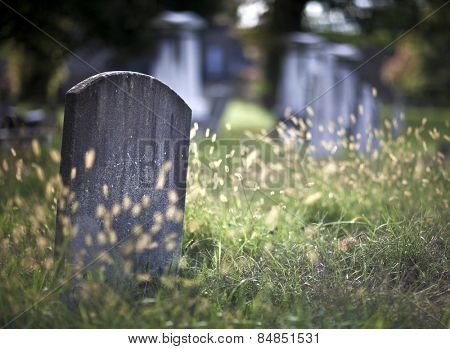 Tombstone and graves in an ancient church graveyard