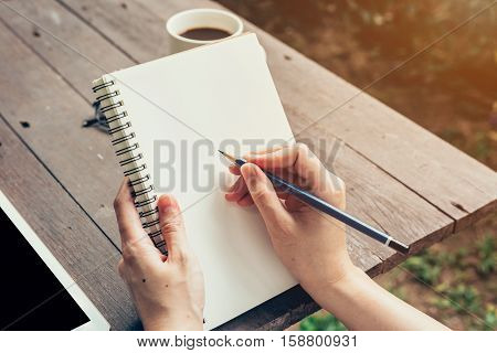 Young Business Woman Hand With Pencil Writing On Notebook. Woman Hand With Pencil Writing On Noteboo