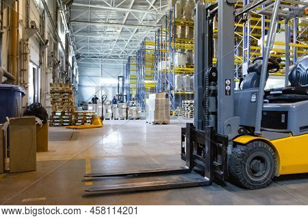 Interior Of A Modern Warehouse With Forklifts. Pallet Stacker Truck Equipment At Warehouse. Forklift