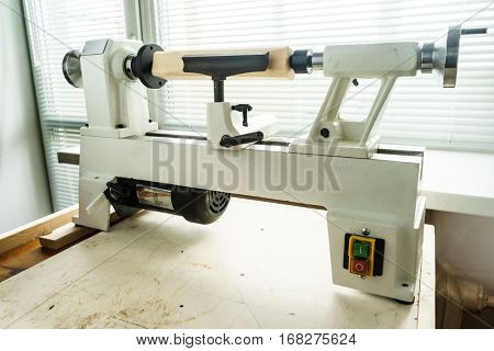 Woodworking Machine, Mini Woodworking Lathe Close Up Detail, Wood Shavings Tools, Woodworking Machinery, Small Woodwork Lathe in a Joinery Workshop, Woodwork on the Machine, Spindle Turning