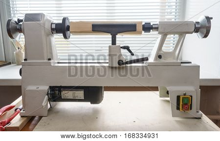 Woodworking Machine, Mini Woodworking Lathe Close Up Detail, Wood Shavings Tools, Woodworking Machinery, Small Woodwork Lathe in a Joinery Workshop, Woodwork on the Machine, Spindle Turning