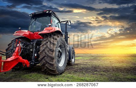 Tractor Working On The Farm, A Modern Agricultural Transport, A Farmer Working In The Field, Tractor