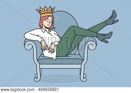 Confident Young Woman In Crown Sitting On Chair. Smiling Girl In Golden Accessory Show Confidence An