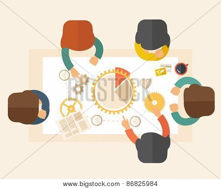 A meeting  of a business people sitting facing each other in the office with coffee and papers on the table in front of them. Sharing and gathering ideas for their marketing plan. Teamwork concept.