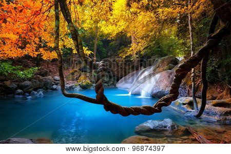 Amazing beauty of Asian nature. Tropical waterfall flows through dense jungle forest and falls into wild pond 