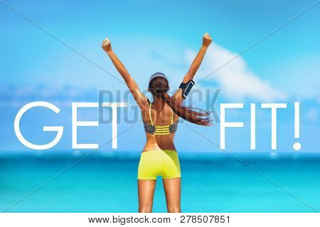 Get FIT motivational message weight loss poster for fitness concept. New Year resolution inspirational quote on beach background. Cheering winner woman with arms up training goal getting in shape.