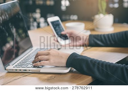 Business Woman Working On Laptop And Use Smartphone,student Typing Report And Research In Library.be