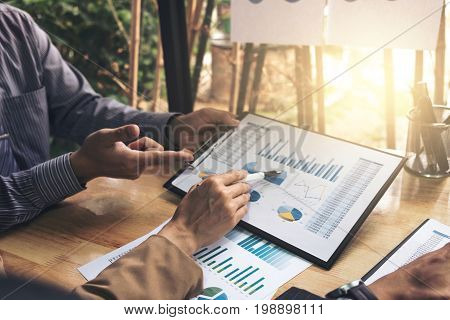 Co working conference Business team meeting present investor colleagues discussing new plan financial graph data on office table with laptop and digital tablet Finance accounting investment.