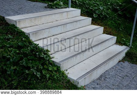 Concrete Stairs To The Park Serving At The Same Time As A Sitting Bench. Gray Cement Clean Smooth Br