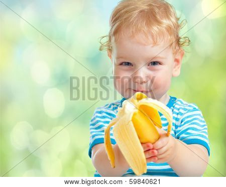 happy kid eating banana fruit. healthy food eating concept.