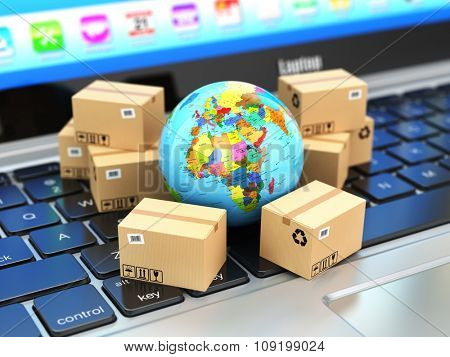 Shipping, delivery and logistic concept. Earth and cardboard boxes on laptop keyboard. Online technology. 3d