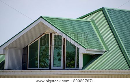 The House With Plastic Windows And A Green Roof Of Corrugated Sh