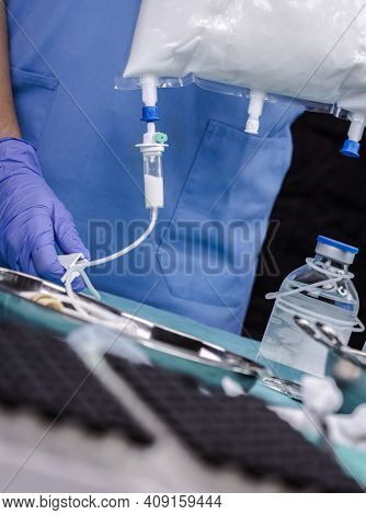 Nurse Shaking Enteral Nutrition Bottle In A Hospital, Palliative Care, Conceptual Image