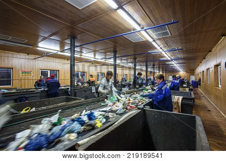 GRODNO BELARUS - OCTOBER 16 2017: Separate garbage collection. Recycling and storage of waste for further disposal. Workers sorting material to be processed in a modern waste recycling plant