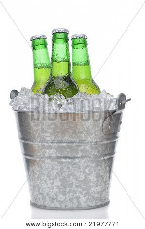 Three Green Beer Bottles in Ice Bucket with Condensation isolated on white vertical composition with reflection