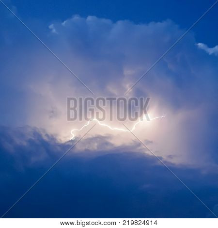 Lightnings in storm clouds. Peals of a thunder and the sparkling lightnings in clouds.