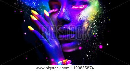 Fashion model woman in neon light, portrait of beautiful model with fluorescent make-up, Art design of female disco dancers posing in UV, colorful make up. Isolated on black background