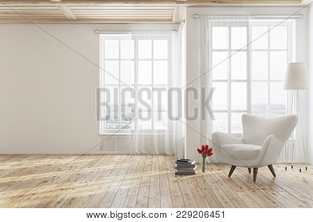 Empty White Living Room Interior With A Wooden Floor, Tall Windows And A White Armchair Near A Stack