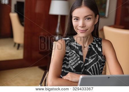 Asian professional woman portrait. Young confident multiracial chinese office worker smiling businesspeople: lawyer, accountant entrepreneur working at home remote freelance work.