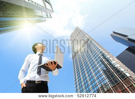 Business Man With Laptop And Look Sky And Cloud