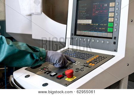 Hand On The Control Panel Of A Computer Numerical Control Programmable Machine