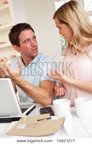 Young couple discussing their finance over laptop computer