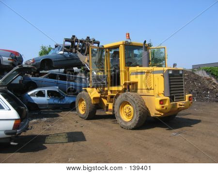 A Truck Lifting A Car Wreck