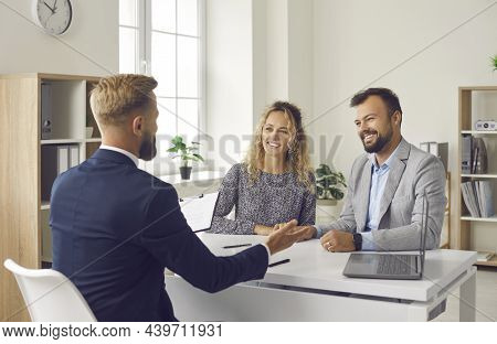 Young Couple Meeting With Loan Broker, Bank Manager, Realtor Or Mortgage Advisor