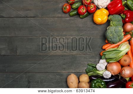 Vegetables on wood background with space for text. Organic food.