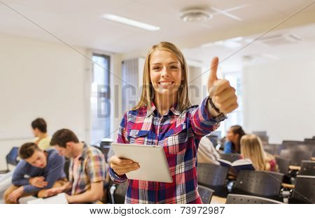 education, high school, teamwork and people concept - group of smiling students with tablet pc computer howing thumbs up in lecture hall