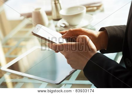 Businesswoman Texting With Her Mobile During A Coffee Break