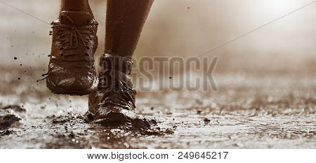 Mud Race Runners Detail Of The Legs,muddy Running Shoes A Run In The Mud