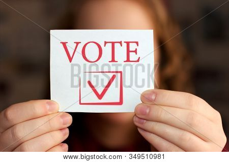 Vote Sign In Young Womans Hands The Concept Of Voting, Making Choices. Presidential And Parliamentar