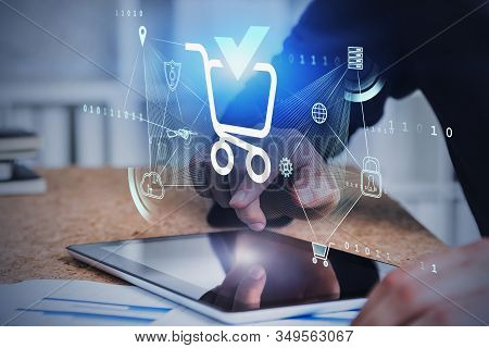 Hands Of Man Using Tablet In Blurry Office With Double Exposure Of Futuristic Online Shopping Interf