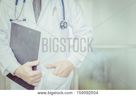 close up of patient and doctor taking notes vintage tone. Doctor man. Doctor woman. Uniform doctor. Tool doctor. Clipboard in hand doctor. Doctor room. Doctor concept.