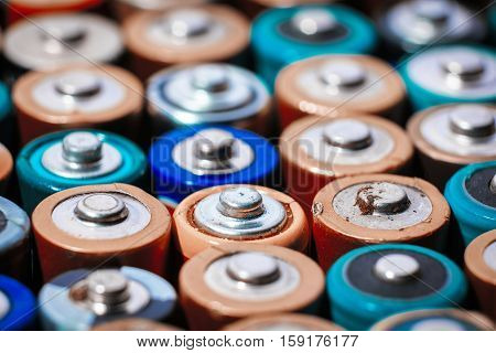 Close up top view on rows of selection of AA batteries energy abstract background of colorful batteries. Alkaline battery aa size. Several batteries are next to each other. Many aa batteries.