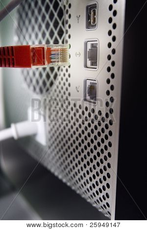 Connecting a computer to a network with a CAT5 ethernet connector.