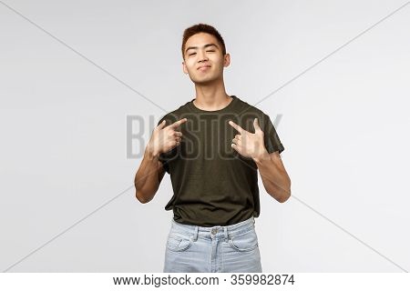 Portrait Of Proud And Boastful Young Asian Macho Man, Show-off His Big Ego, Pointing At Himself With