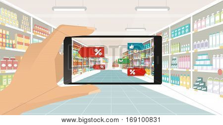 Man doing grocery shopping at the supermarket he is viewing offers and augmented reality contents on his smartphone store aisle and shelves on the background subjective point of view