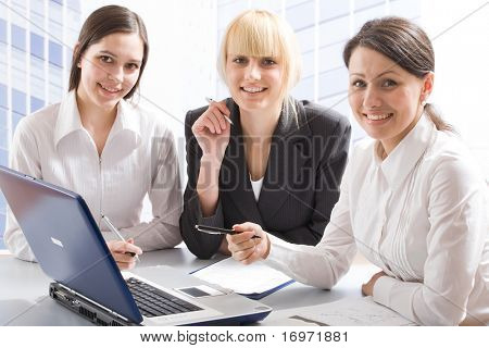 Three young professionals looking at camera