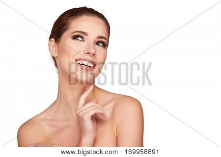 Beautiful Young Woman with Clean Fresh Skin close up isolated on white. Beauty Girl Portrait. Spa Woman Smiling and touching her skin. Perfect Fresh Skin.