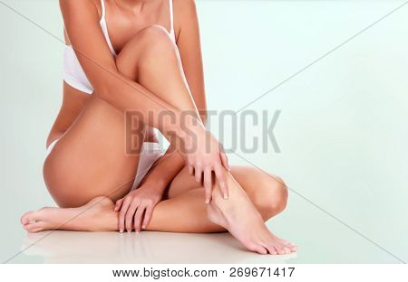 Young woman with slim body and smooth clean skin. Laser hair removal concept