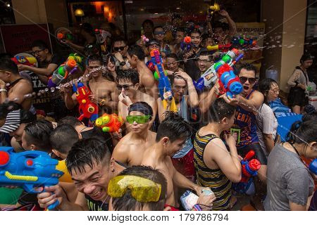 Bangkok, Thailand - April 13, 2014 : The Songkran festival or Thai New Year's festival on Silom street in Bangkok, Thailand.