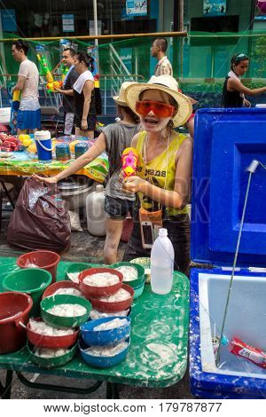 Bangkok, Thailand - April 13, 2014 : The Songkran festival or Thai New Year's festival on Silom street in Bangkok, Thailand.