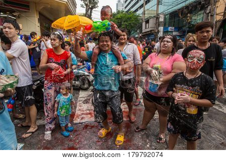 Bangkok, Thailand - April 13, 2014 : The Songkran festival or Thai New Year's festival on Silom street in Bangkok, Thailand.