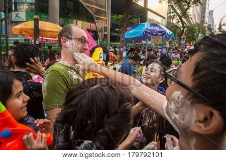 Bangkok, Thailand - April 13, 2014 : The Songkran festival or Thai New Year's festival on Silom street in Bangkok, Thailand.