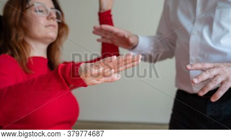 An Elderly Man Hypnotizes A Female Patient. A Woman In A Session With A Male Hypnotherapist During A