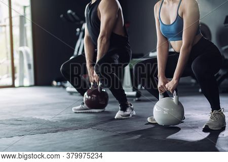 Sporty Team With Kettlebells And Exercise Workout At Fitness Gym With Personal Trainer Coaching, Spo